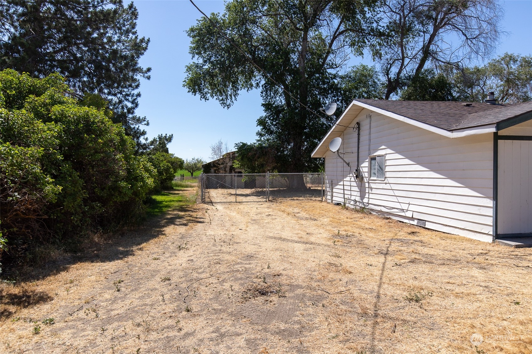 4838 Rd L.9 Northeast Moses Lake, WA 98837 - Photo 5 of 20 a view of a white house with a yard covered with snow in the background