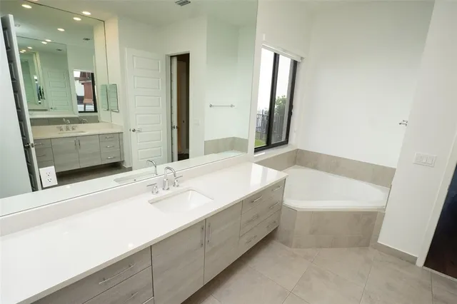 a bathroom with a bathtub and a sink