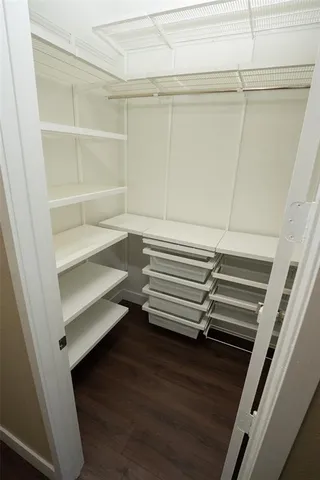 a view of walk in closet with empty racks