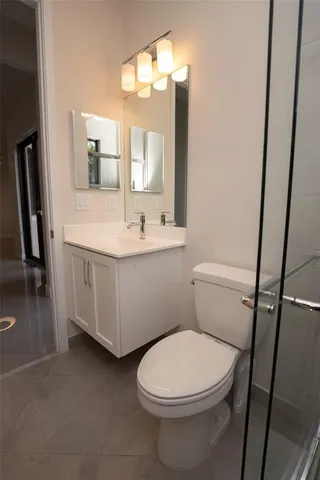 a bathroom with a toilet a sink and mirror