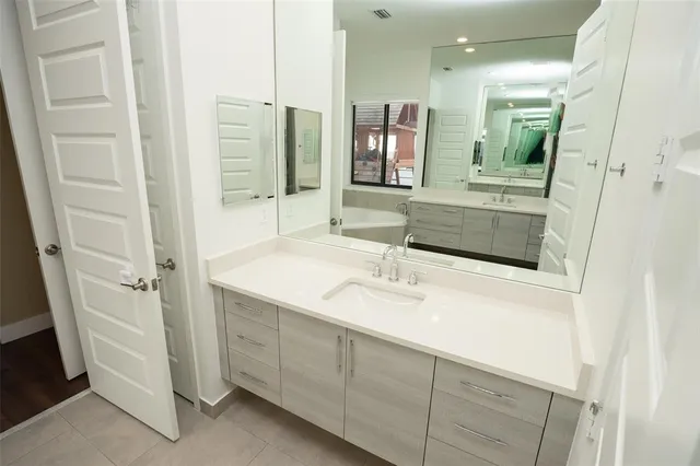 a bathroom with a granite countertop sink mirror and double