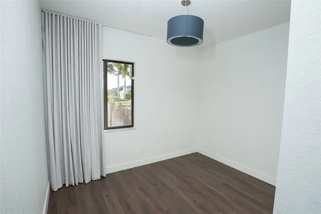 a view of an empty room and a window