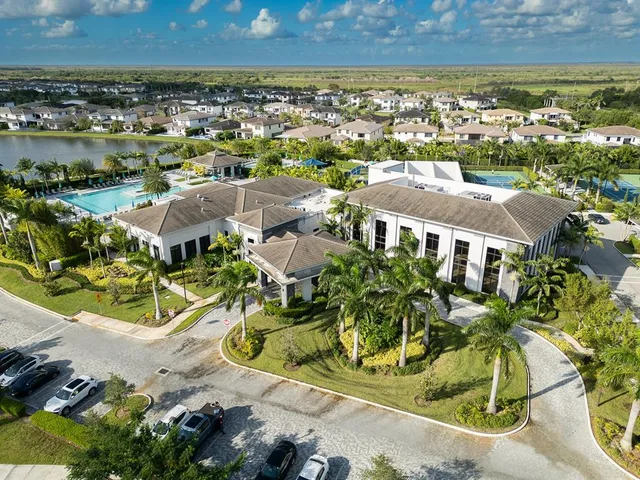 an aerial view of residential houses with outdoor space and swimming pool