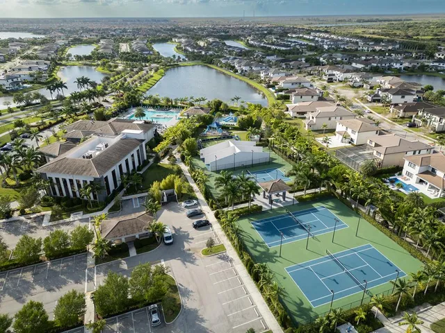 an aerial view of multiple houses with yard
