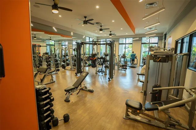 a view of a living room with floor to ceiling windows with wooden floor