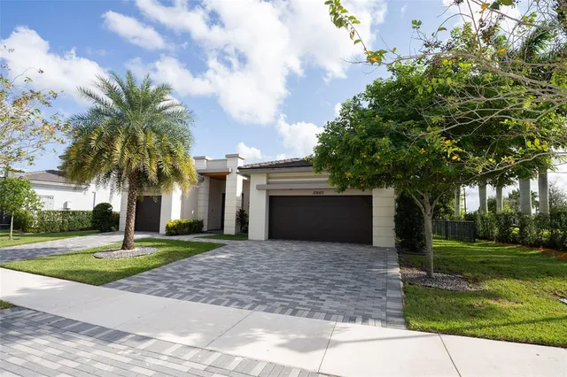 a front view of a house with yard and green space