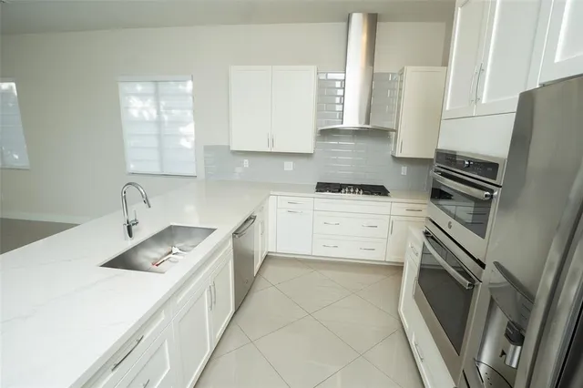 a kitchen with a sink stove and refrigerator