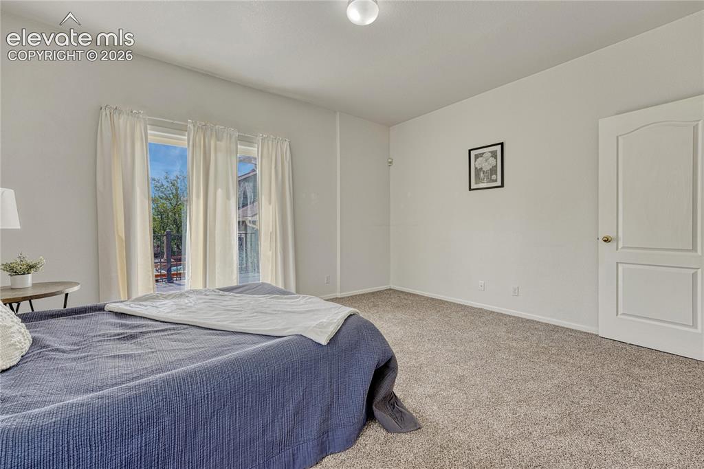 7285 Julynn Road Colorado Springs, CO 80919 - Photo 23 of 45 a bedroom with a bed and a window