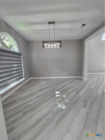 a view of a livingroom with wooden floor and window