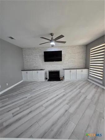 a living room with a couch and a ceiling fan