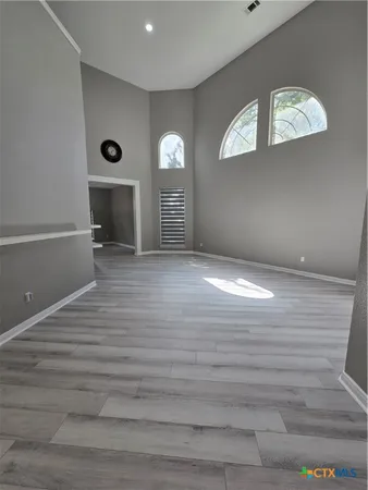 a view of empty room with window and fireplace