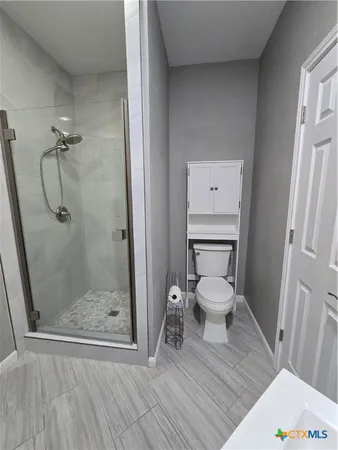 a white toilet sitting next to a bathroom sink