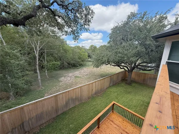 a view of a balcony with yard