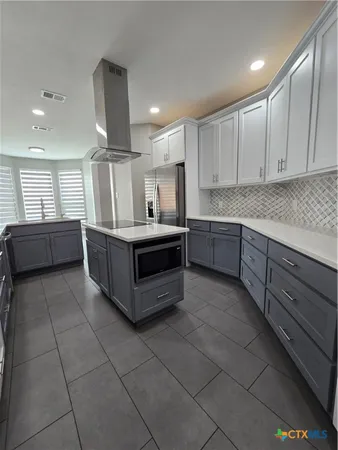 a kitchen with stainless steel appliances granite countertop a sink and cabinets
