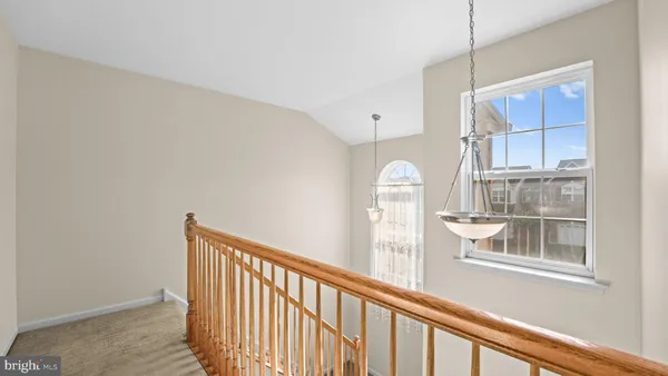 a view of a kitchen with wooden floor and windows