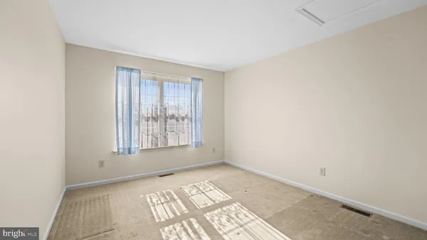 a view of an empty room and window