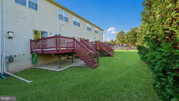 a view of a house with a backyard and a deck