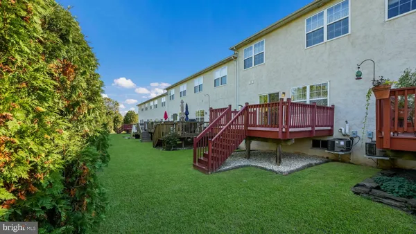 a view of backyard with deck and outdoor seating
