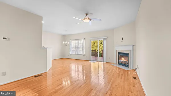 a view of an empty room with a fireplace and a window