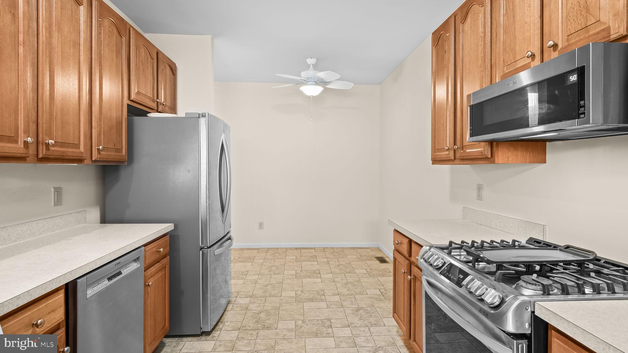 435 Buchanan Road Perkasie, PA 18944 - Photo 10 of 32 a kitchen with stainless steel appliances granite countertop a stove and a microwave with cabinets