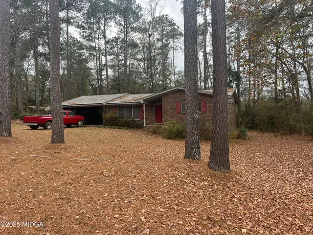 a backyard of a house with table and chairs