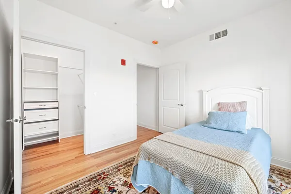 a bedroom with a bed and wooden floor