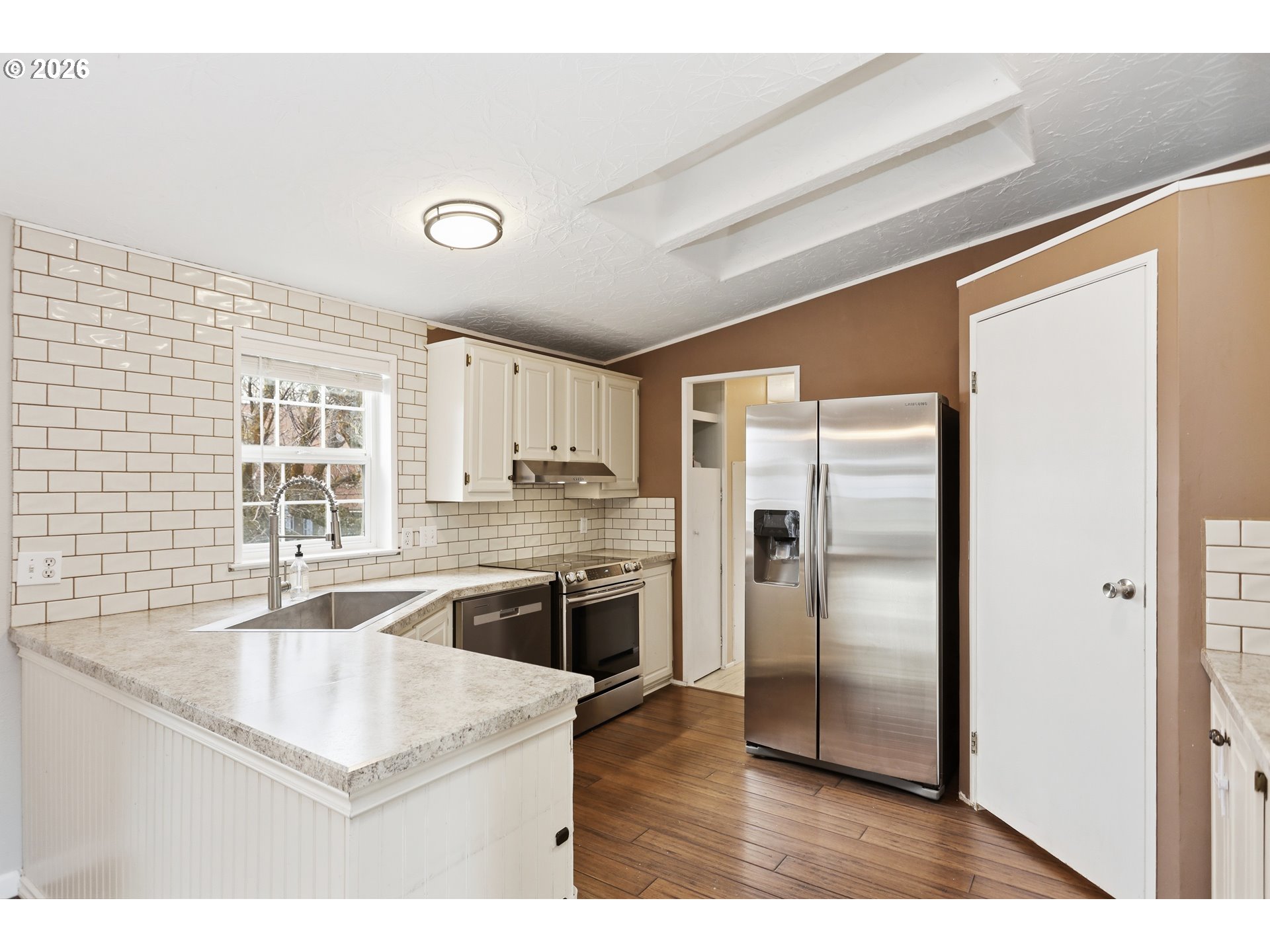 501 Northwest 3rd Street Dufur, OR 97021 - Photo 13 of 44 a kitchen with stainless steel appliances granite countertop a refrigerator a sink and a stove