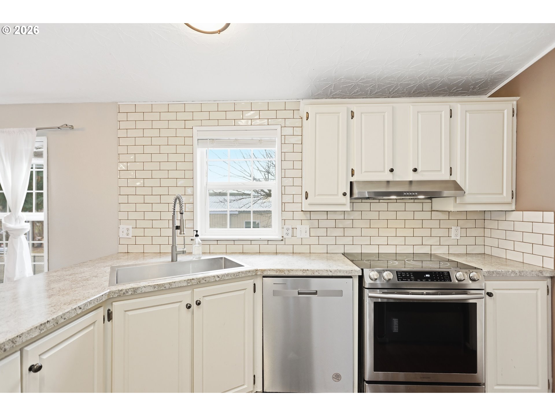501 Northwest 3rd Street Dufur, OR 97021 - Photo 15 of 44 a kitchen with stainless steel appliances granite countertop a sink dishwasher a stove and a microwave