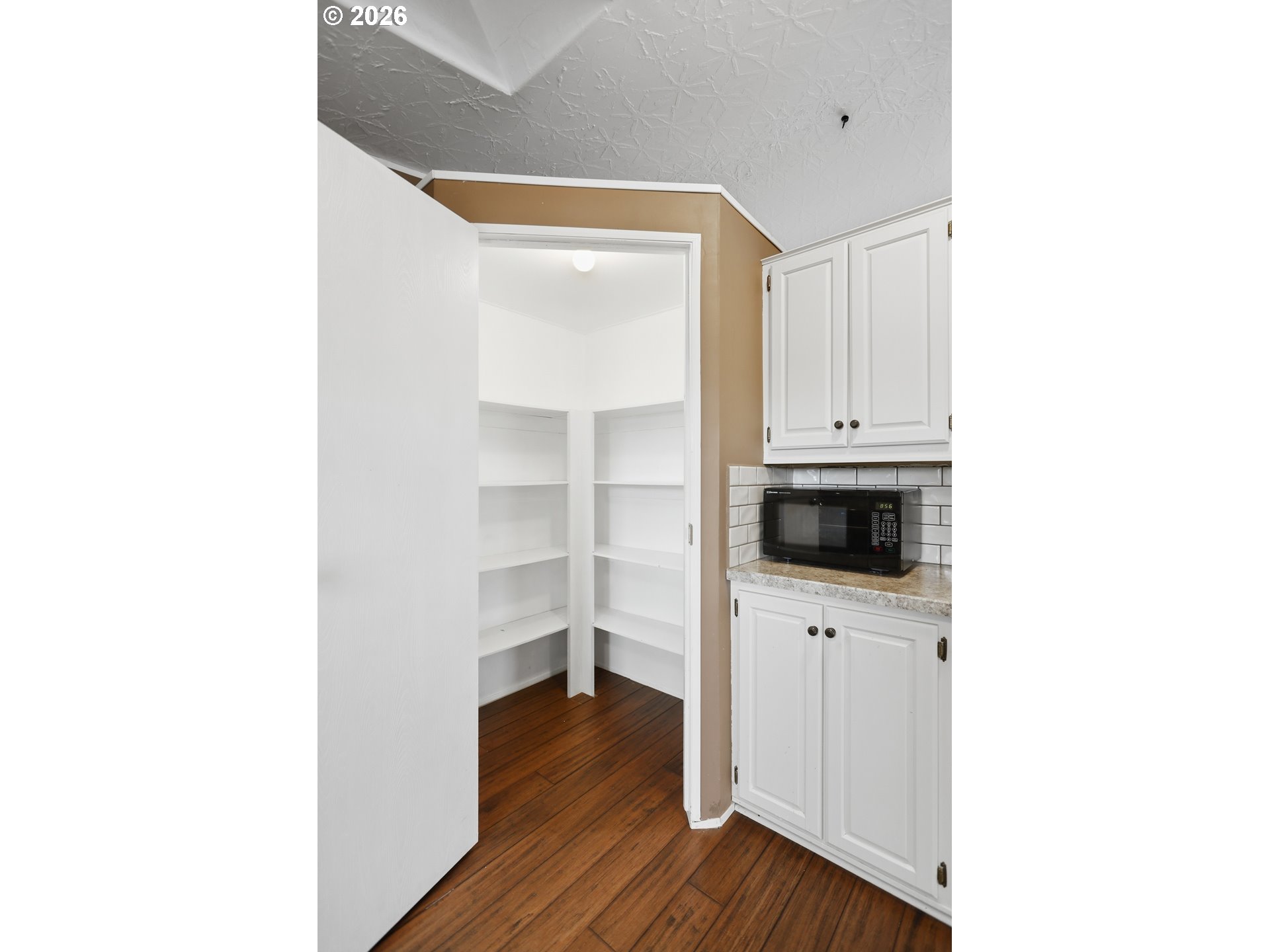 501 Northwest 3rd Street Dufur, OR 97021 - Photo 16 of 44 a view of a kitchen with a sink and a microwave
