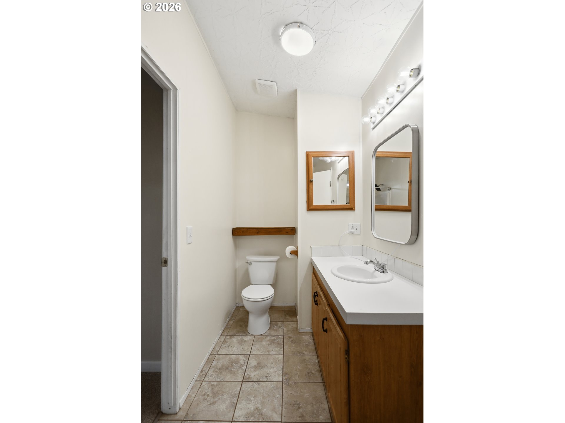 501 Northwest 3rd Street Dufur, OR 97021 - Photo 21 of 44 a bathroom with a sink a toilet and a mirror