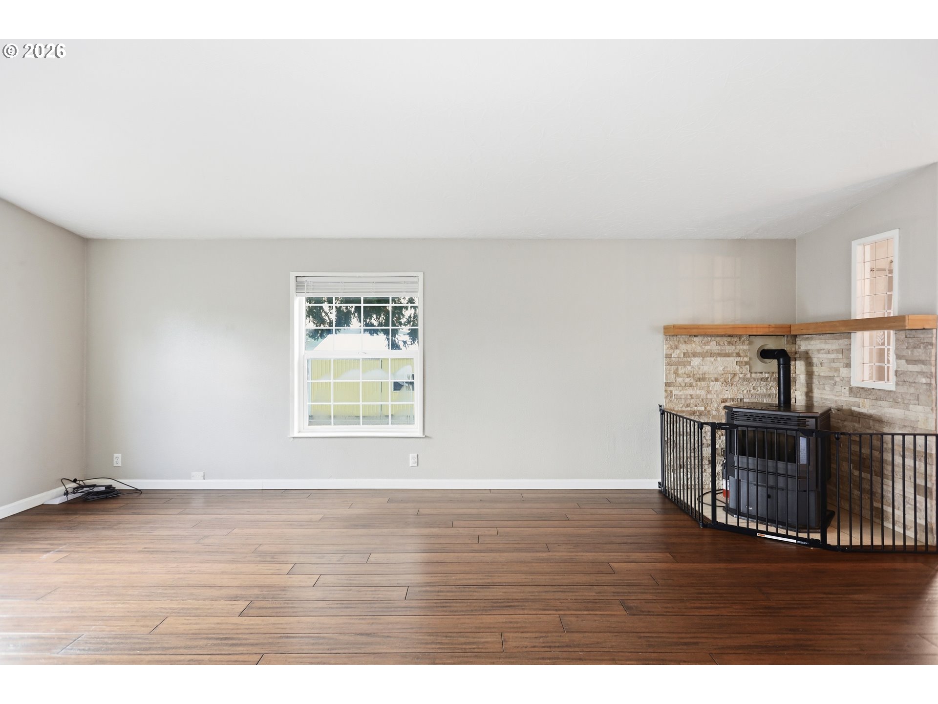 501 Northwest 3rd Street Dufur, OR 97021 - Photo 28 of 44 a view of an empty room with wooden floor and a window