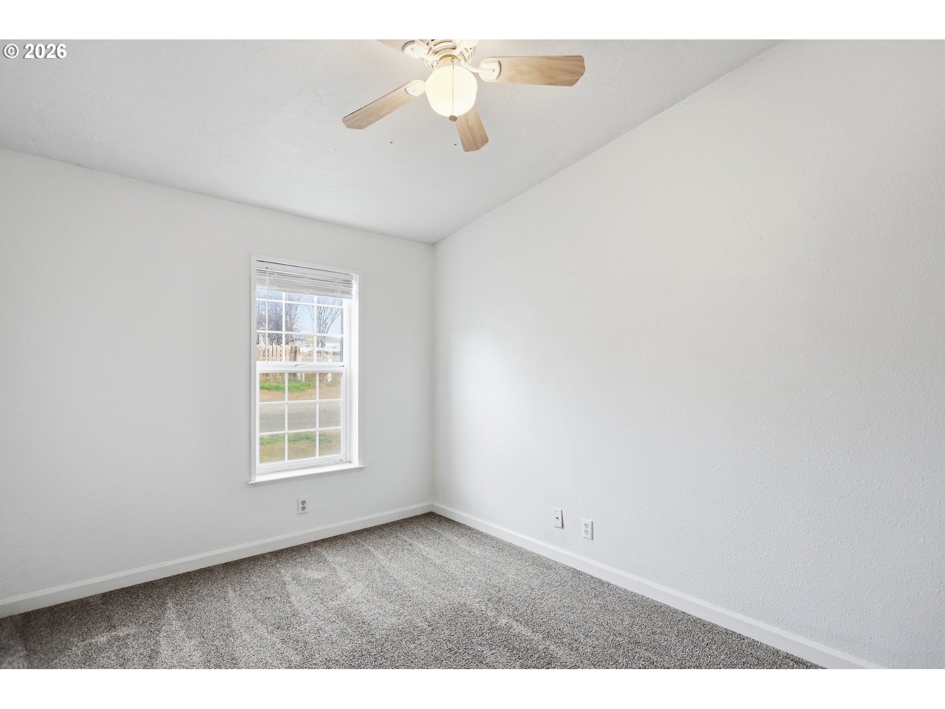 501 Northwest 3rd Street Dufur, OR 97021 - Photo 35 of 44 an empty room with windows and ceiling fan