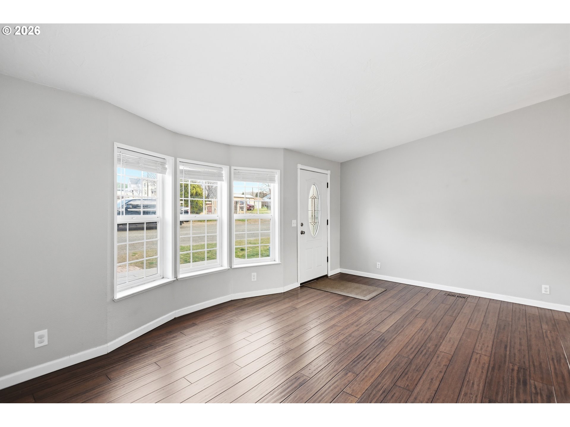 501 Northwest 3rd Street Dufur, OR 97021 - Photo 9 of 44 an empty room with wooden floor and windows