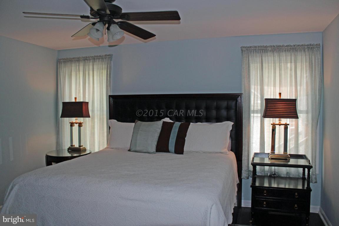 76 Pinehurst Road Ocean Pines, MD 21811 - Photo 16 of 23 a bedroom with a bed and wooden floor