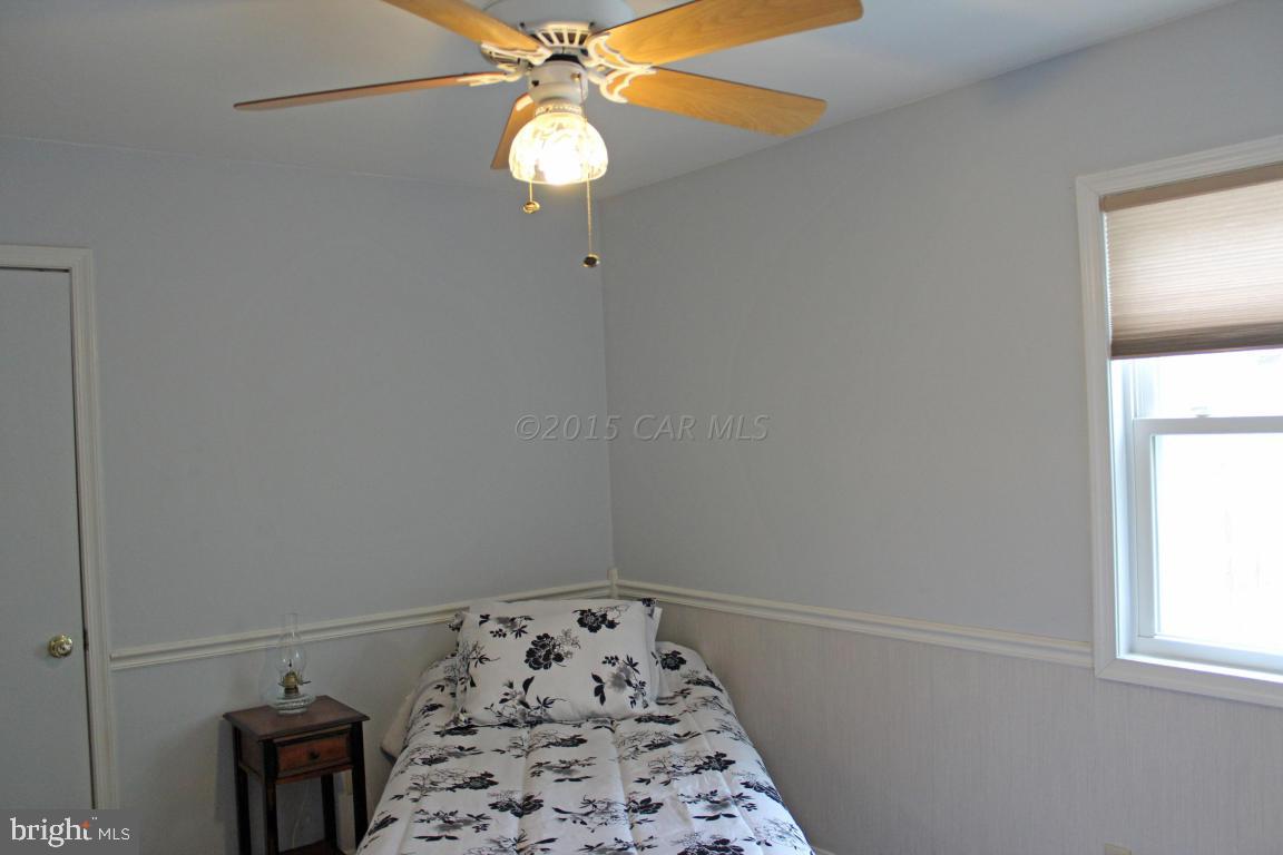 76 Pinehurst Road Ocean Pines, MD 21811 - Photo 18 of 23 an empty room with windows and fan
