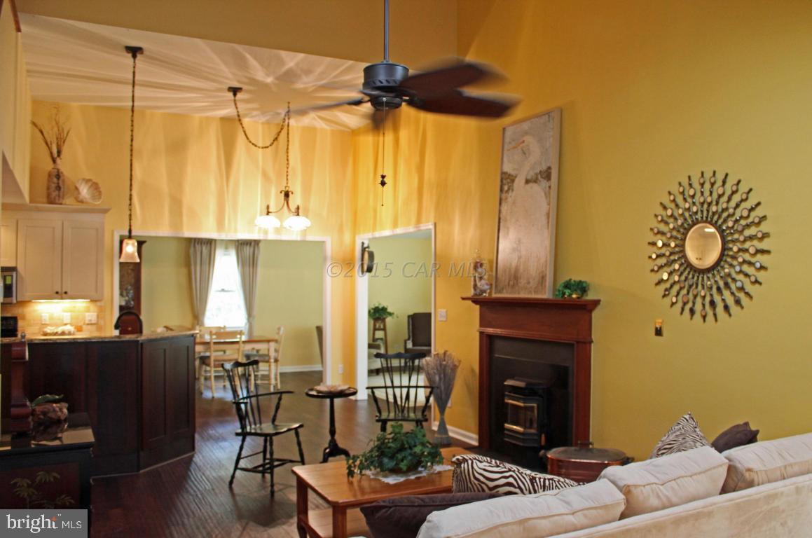 76 Pinehurst Road Ocean Pines, MD 21811 - Photo 3 of 23 a living room with furniture a fireplace and a table
