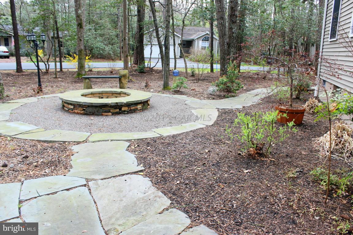 76 Pinehurst Road Ocean Pines, MD 21811 - Photo 22 of 23 a couple of white chairs sitting in backyard with plants