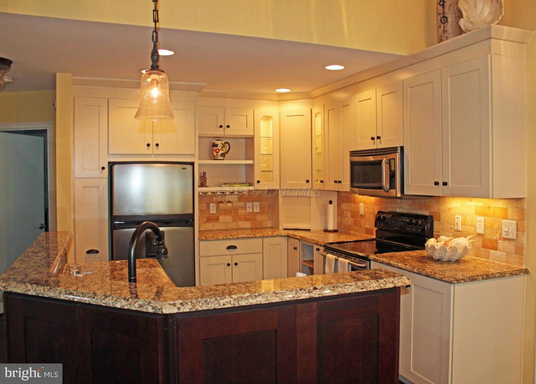 76 Pinehurst Road Ocean Pines, MD 21811 - Photo 5 of 23 a kitchen with stainless steel appliances granite countertop a sink a stove and a refrigerator