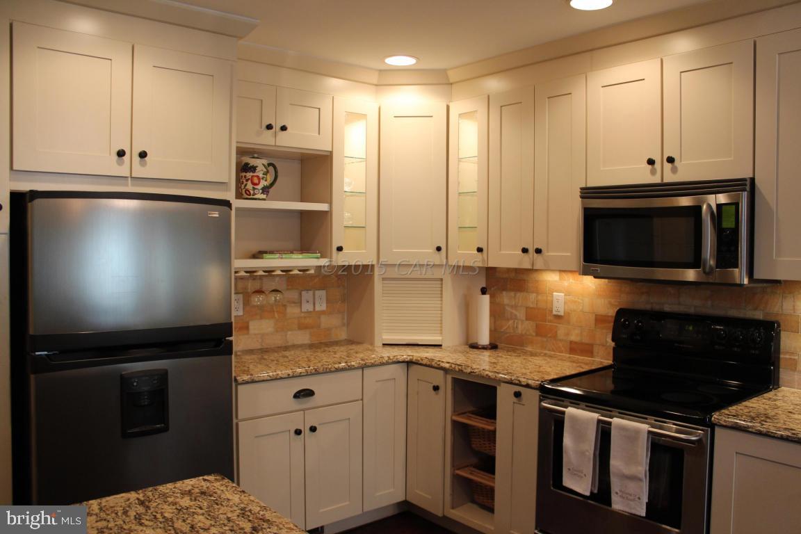 76 Pinehurst Road Ocean Pines, MD 21811 - Photo 6 of 23 a kitchen with stainless steel appliances granite countertop a stove a refrigerator and a microwave