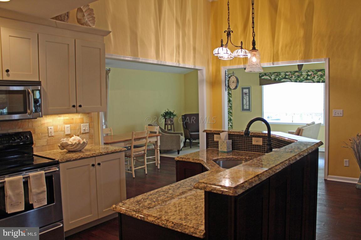 76 Pinehurst Road Ocean Pines, MD 21811 - Photo 8 of 23 a kitchen with kitchen island granite countertop a sink stainless steel appliances and cabinets