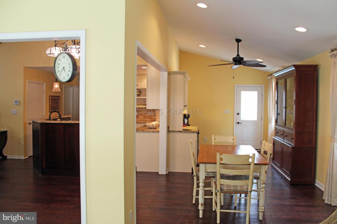 76 Pinehurst Road Ocean Pines, MD 21811 - Photo 10 of 23 a view of a hallway with wooden floor fireplace and living room