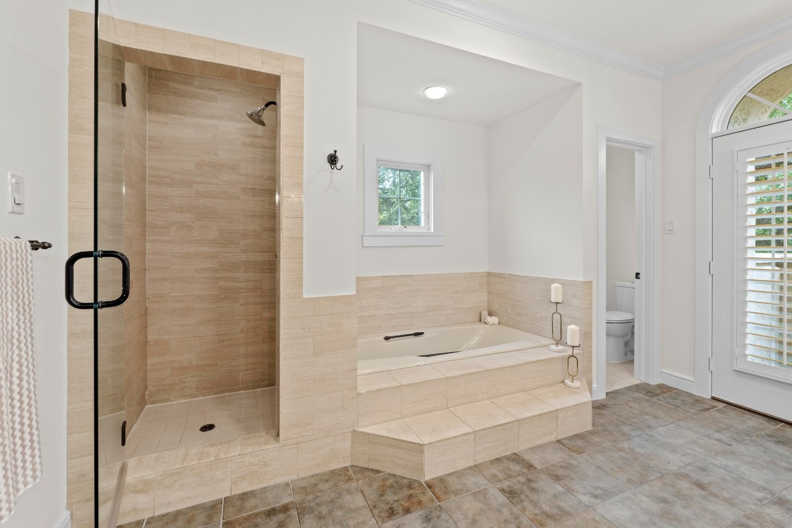 1937 Rue De St Tropez, Unit 5 Austin, TX 78746 - Photo 16 of 36 a bathroom with a tub sink and shower