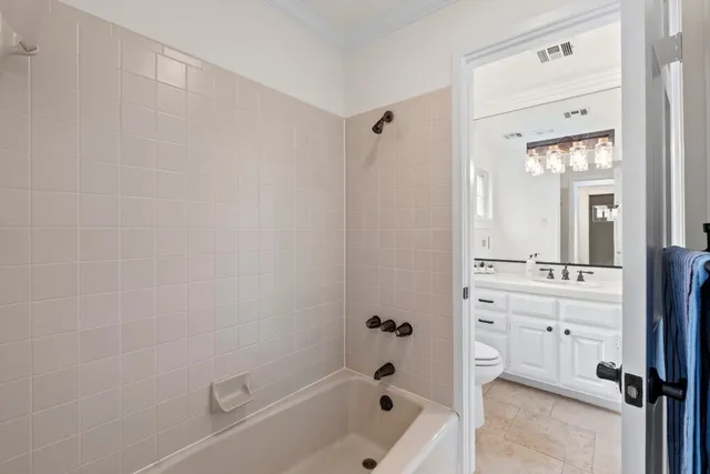 a bathroom with a tub a sink and a mirror