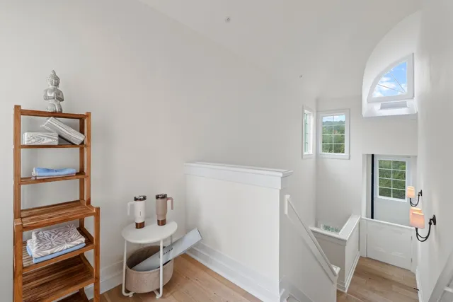 a view of a room with furniture and wooden floor