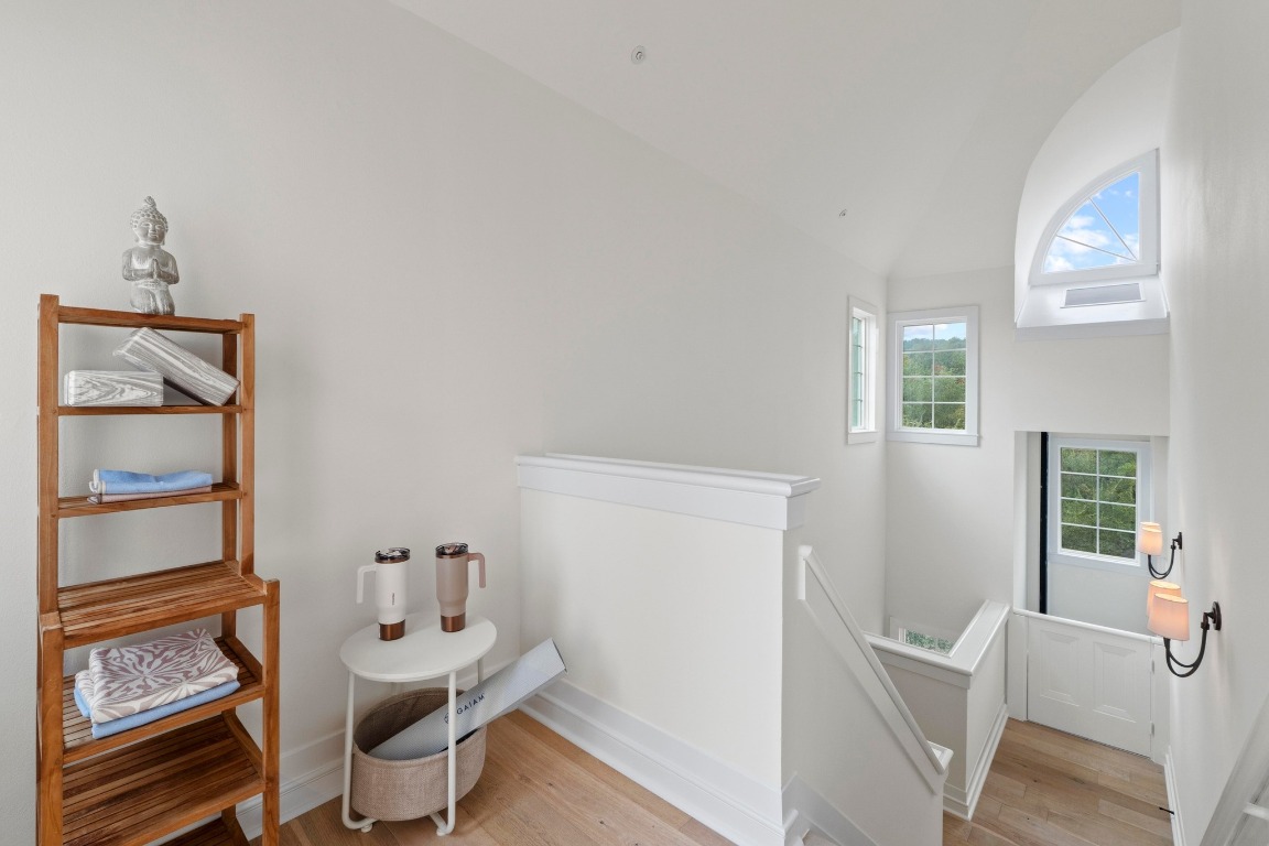 1937 Rue De St Tropez, Unit 5 Austin, TX 78746 - Photo 24 of 36 a view of a room with furniture and wooden floor