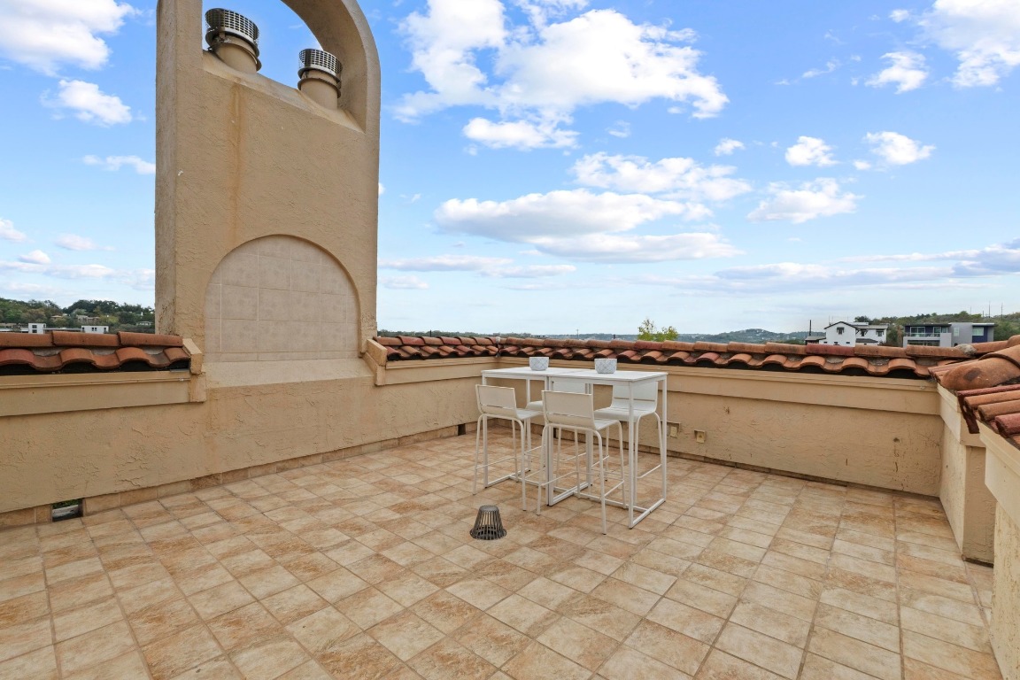 1937 Rue De St Tropez, Unit 5 Austin, TX 78746 - Photo 25 of 36 a terrace with outdoor seating and city view