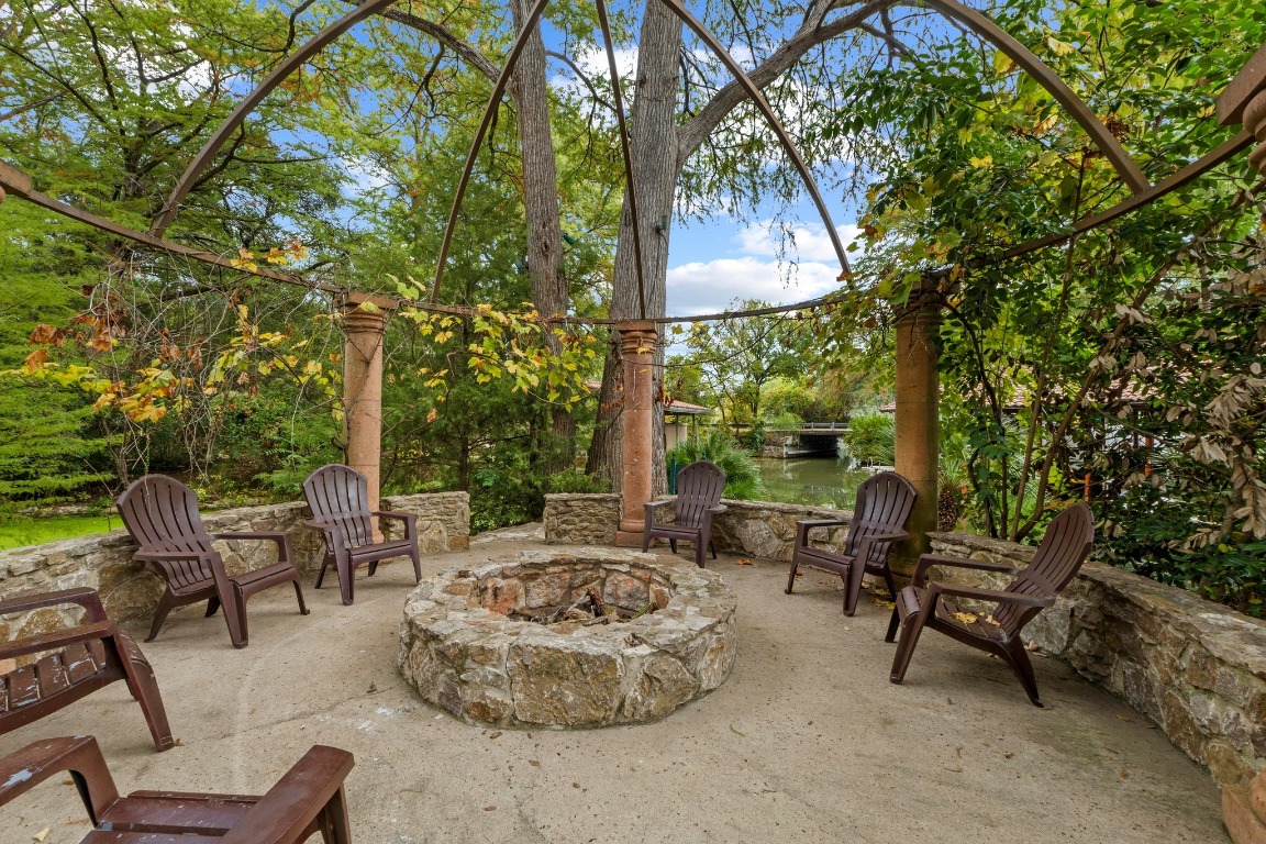 1937 Rue De St Tropez, Unit 5 Austin, TX 78746 - Photo 30 of 36 a backyard of a house with outdoor seating