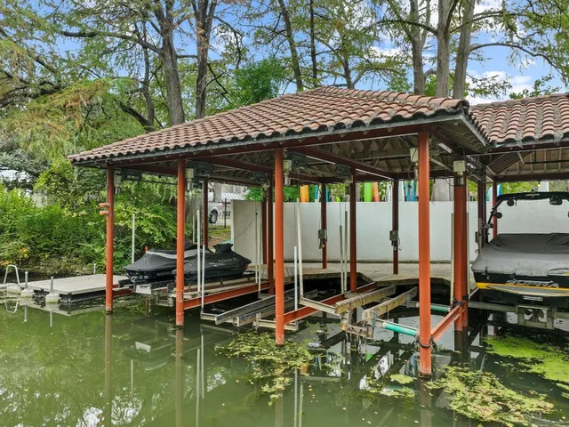 a view of a patio with table and chairs under an umbrella