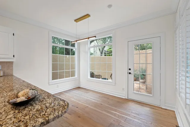 a view of a bedroom with wooden floor and a window