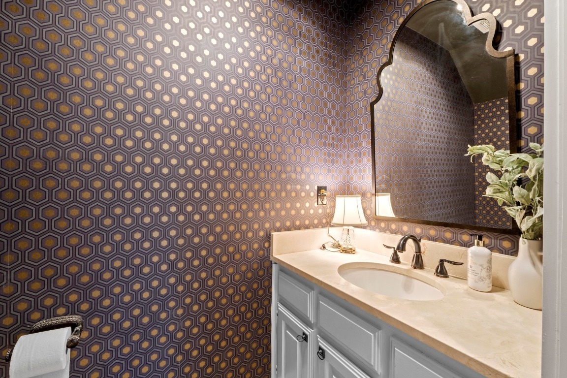 1937 Rue De St Tropez, Unit 5 Austin, TX 78746 - Photo 10 of 36 a bathroom with a granite countertop sink and a mirror